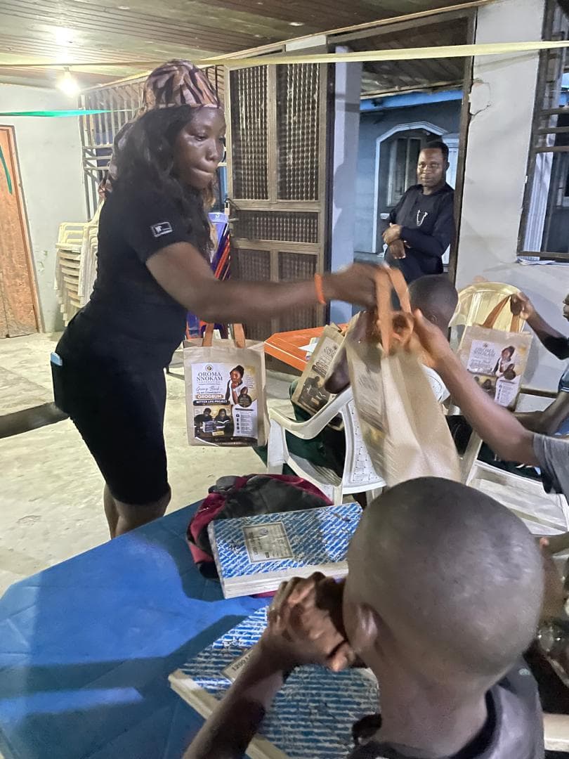 A BLEND volunteer hands out programme materials to a student.