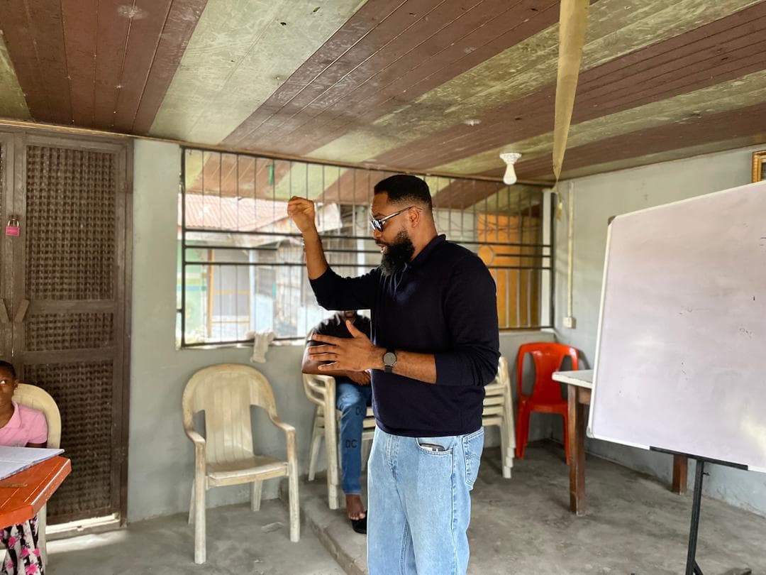 A student receives study materials from a BLEND team member.